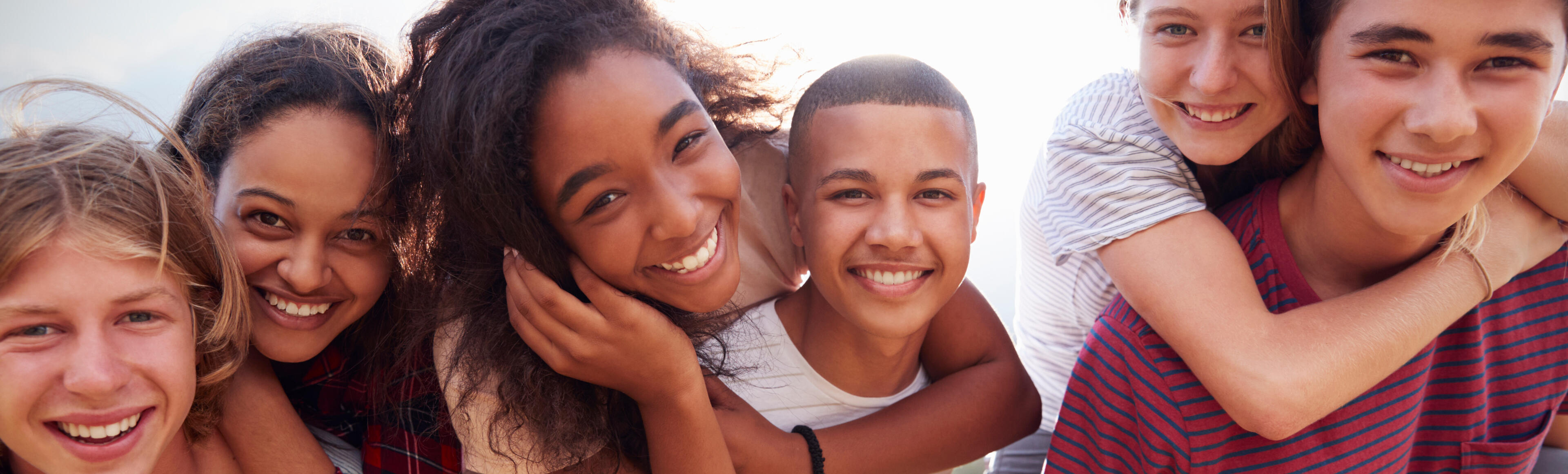Family sitting outside with child holding phone